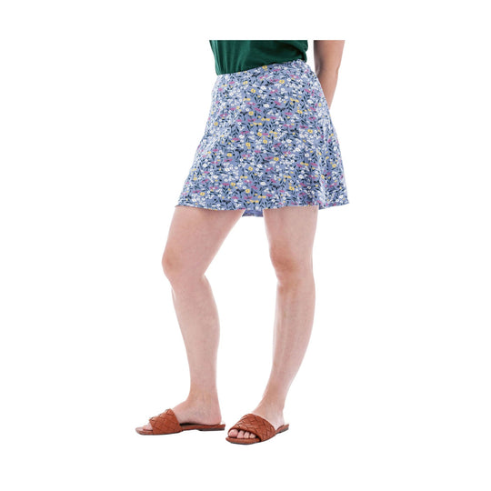 Model wearing a blue floral swing skort with a flared hem and brown woven slide sandals
