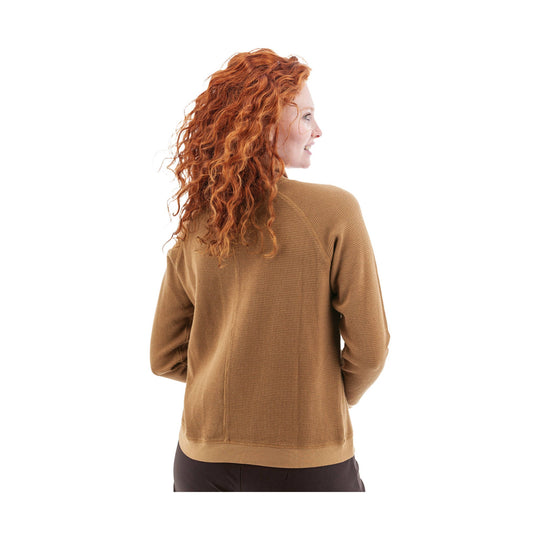 Back view of a brown waffle-knit long-sleeve top on a model with curly red hair
