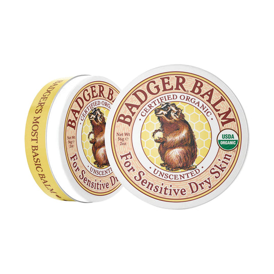 Two tins of unscented balm, one showing the front label and one the side label, with a bear illustration.