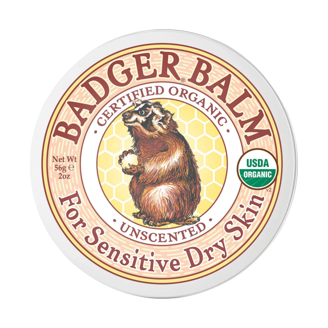 Round tin label for a balm with a badger illustration, honeycomb background, and USDA Organic seal