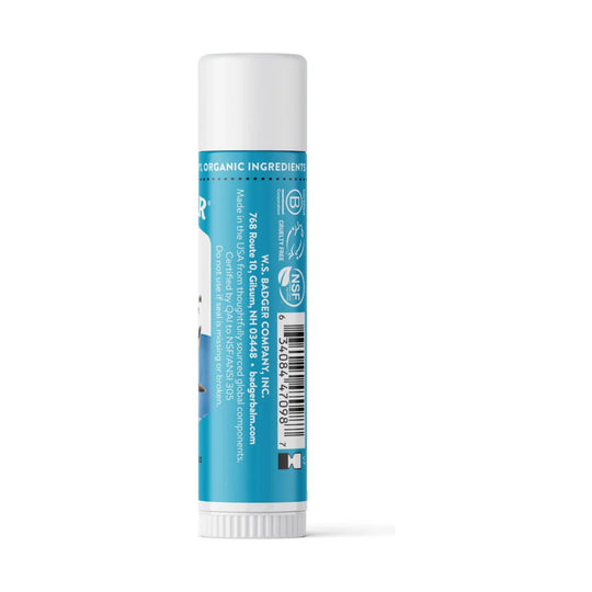 Blue lip balm tube with white cap and printed barcode, shown standing upright