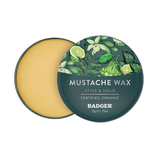Open round tin of mustache wax with teal lid and floral citrus design, labeled “MUSTACHE WAX” and “STYLE & HOLD”