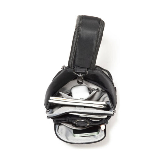 Black sling bag open to show multiple compartments, a front zip pocket, and a padded shoulder strap