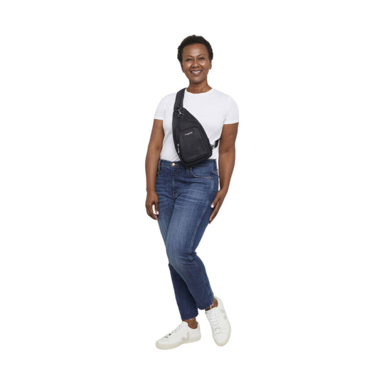 Black crossbody sling bag worn across the chest with a front zip pocket