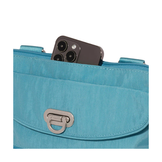 Turquoise crossbody bag with flap closure and front metal clasp, holding a smartphone