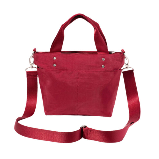 Small red canvas tote bag with top handles, detachable shoulder strap, and silver hardware