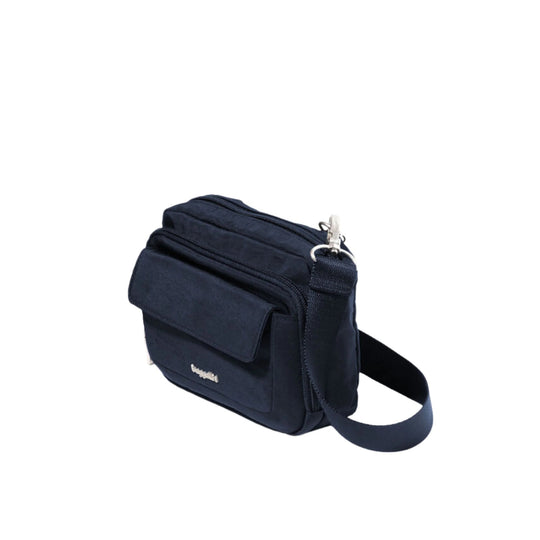 Navy crossbody bag with front flap pocket, top zipper, and adjustable shoulder strap