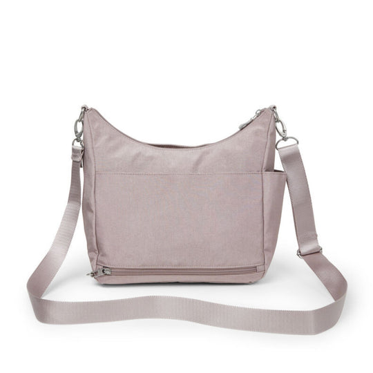 Blush crossbody bag with long adjustable strap, front pocket, and top zipper