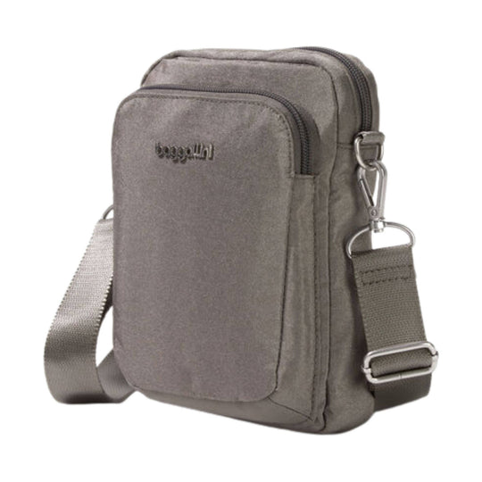 Small gray crossbody bag with front zip pocket, top zipper, and adjustable shoulder strap