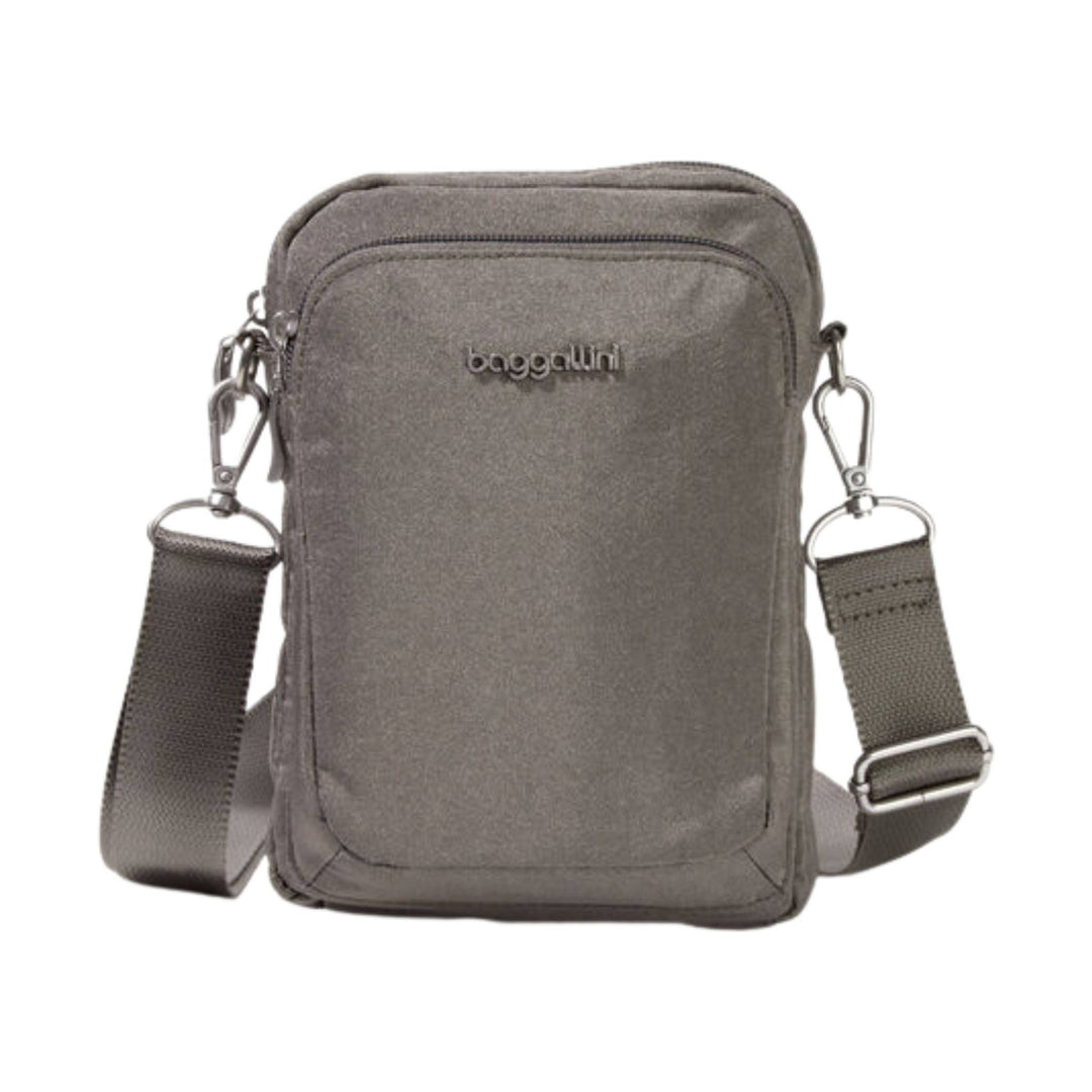 Small gray crossbody bag with front zip pocket, adjustable strap, and visible baggallini logo