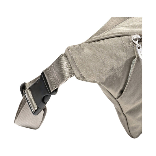 Close-up of a taupe nylon sling bag strap with black buckle and zipper pocket