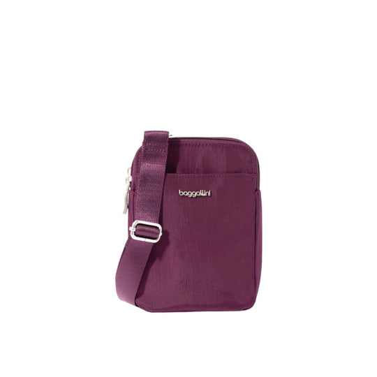 Purple crossbody bag with front zip pocket, adjustable strap, and Baggallini logo