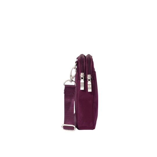 Small plum crossbody bag with two front zippers and an adjustable strap