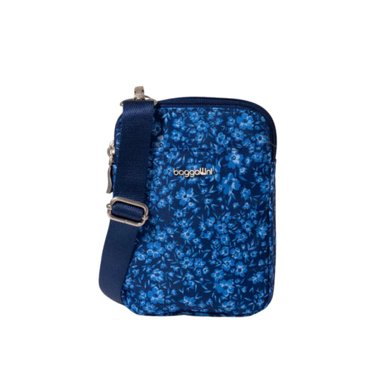 Blue floral crossbody bag with zip closure, adjustable strap, and visible logo.
