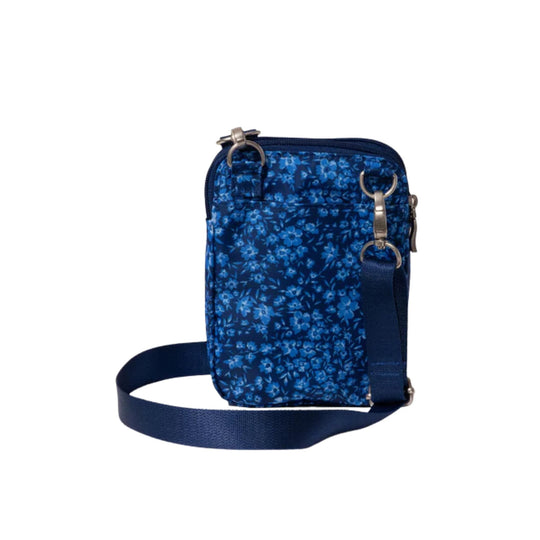 Blue floral crossbody bag with front zip pocket, ring hardware, and navy shoulder strap