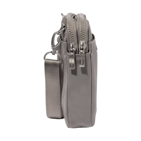 Gray crossbody bag with double front zippers and an adjustable strap