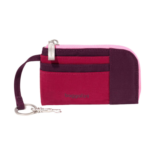 Small zippered card case with wrist strap in magenta, plum, and pink color blocks