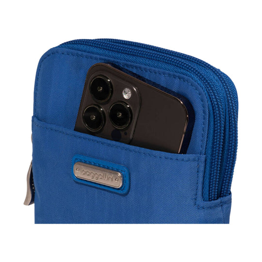 Blue zippered crossbody pouch with a front phone pocket and metal logo plate
