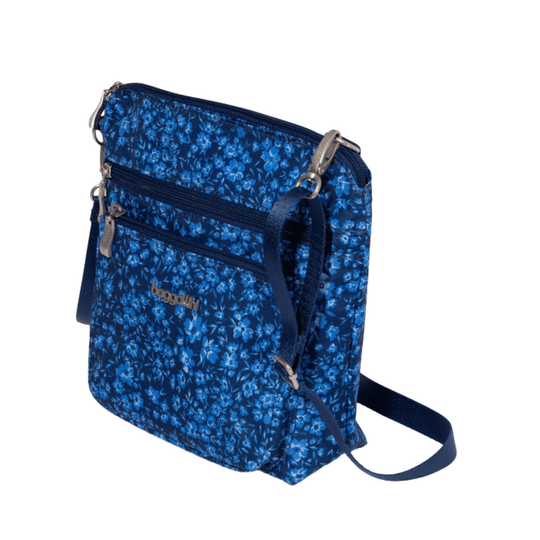 Blue floral crossbody bag with front zip pockets and adjustable strap
