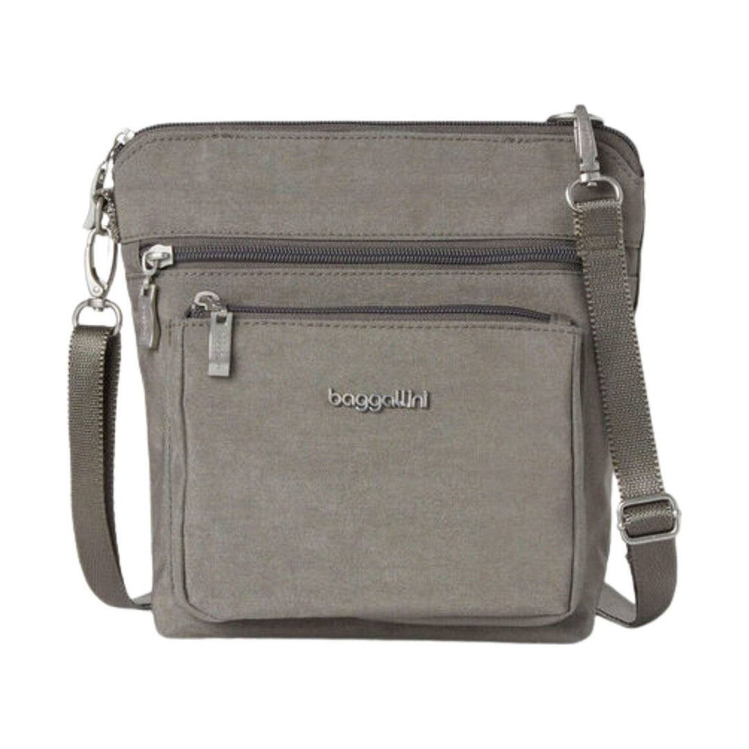 Gray crossbody bag with front zip pockets and an adjustable strap