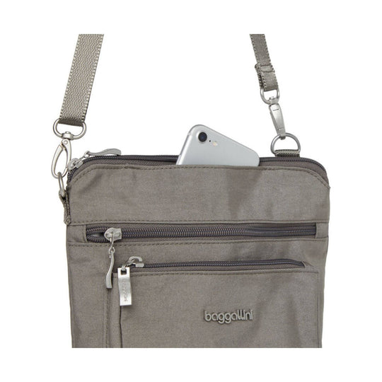 Gray crossbody bag with two front zip pockets, adjustable strap, and a phone peeking out of the top opening