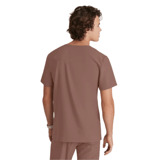 Brown short-sleeve scrub top shown from the back on a model