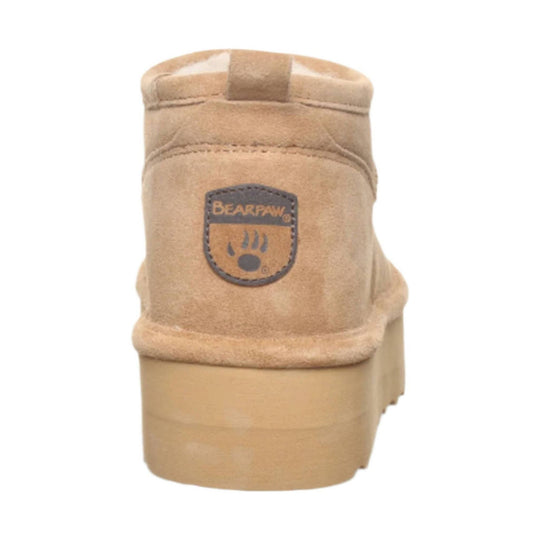 Tan suede ankle boot with a BEARPAW heel patch, rear view