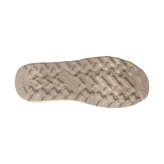Beige rubber boot sole with zigzag tread pattern