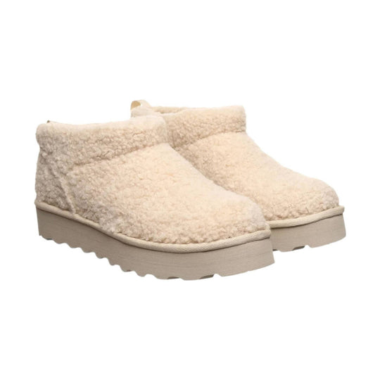 Cream sherpa ankle boot with a beige platform sole