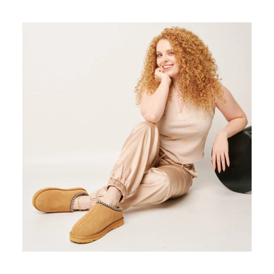 Tan slip-on slippers with faux-shearling lining and thick soles