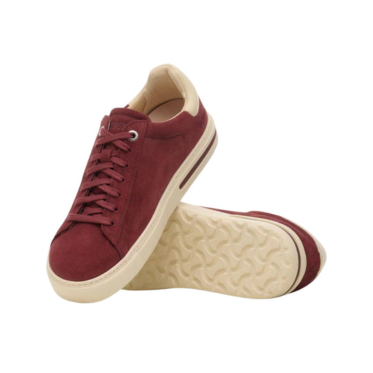Burgundy suede low-top sneakers with cream soles and laces