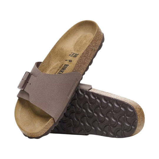 Brown cork footbed sandal with a single buckle strap, shown from the side and underside