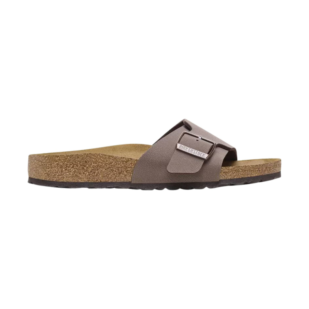 Brown slide sandal with a wide strap, buckle detail, and cork footbed