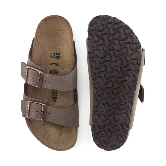Brown double-strap sandals with buckles, cork footbeds, and patterned rubber soles