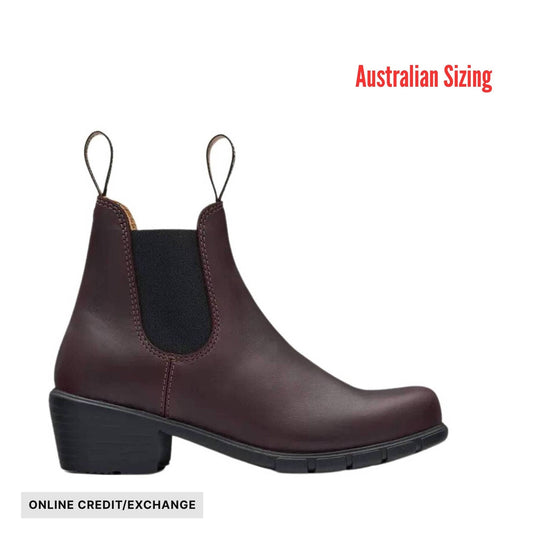 Brown Chelsea-style heeled ankle boot with black sole and pull tabs; text reads Australian Sizing and ONLINE CREDIT/EXCHANGE