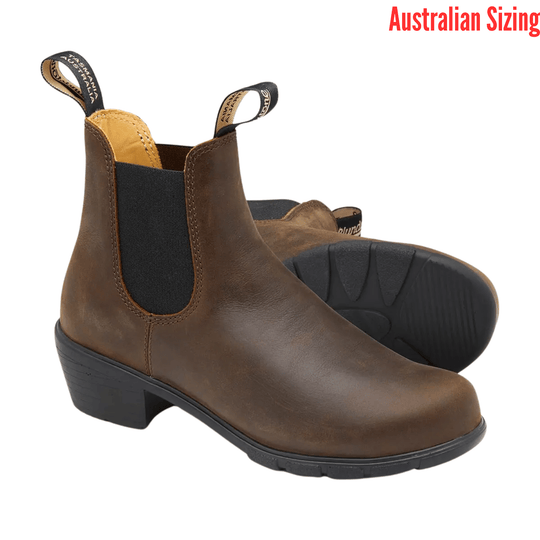 Brown leather heeled Chelsea boot with black elastic side panels and pull tabs, shown in side view