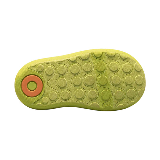 Light green toddler boot sole with circular traction pods and orange heel detail