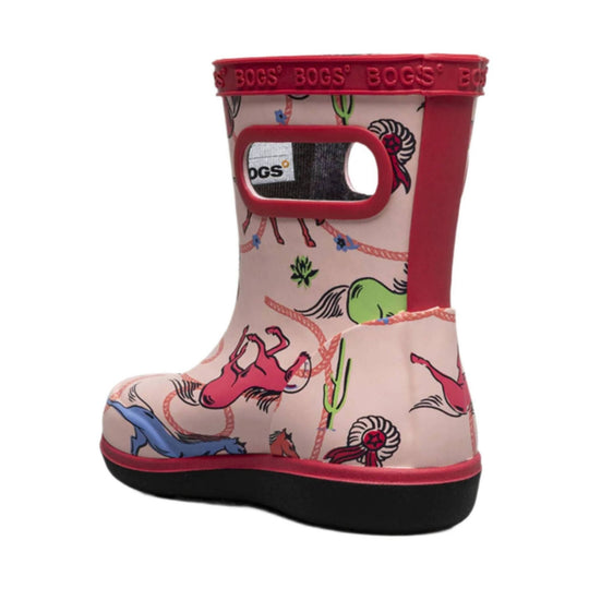 Pink rain boot with red trim, horse-and-lasso print, and side handle opening