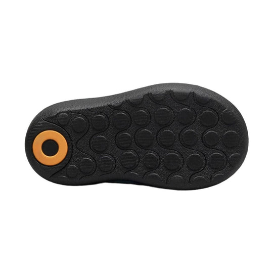 Black boot outsole with circular tread pattern and an orange heel insert