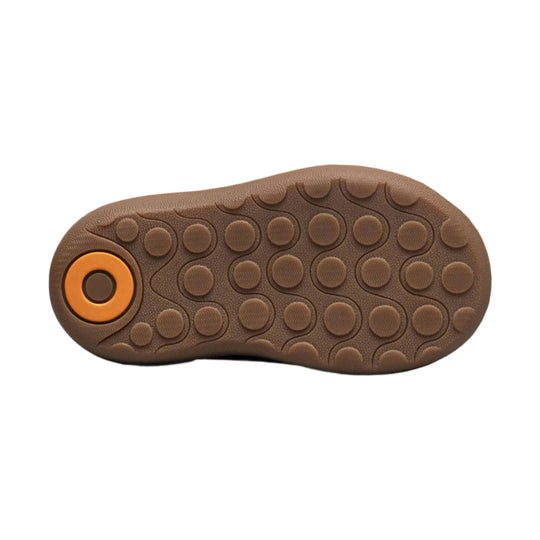 Brown rubber boot sole with circular tread pattern and an orange heel insert