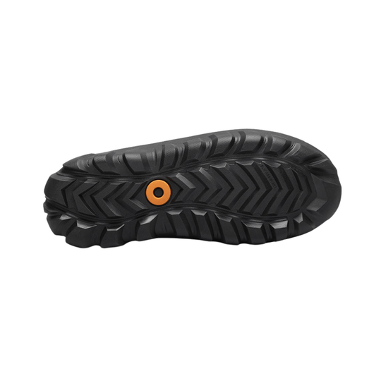 Black boot outsole with deep tread and an orange circular insert