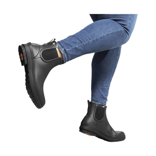 Black Chelsea rain boots worn with blue jeans
