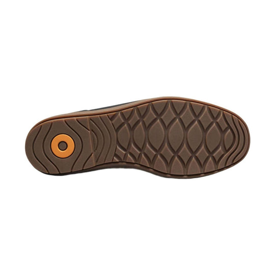 Brown boot outsole with a wavy tread pattern and circular orange accent