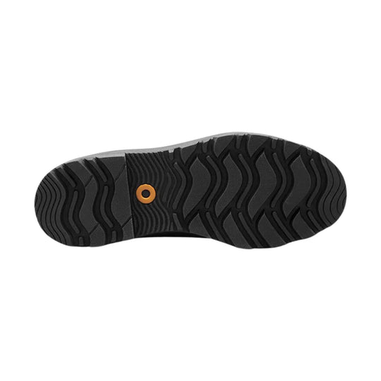 Black boot outsole with wavy tread and an orange circular plug