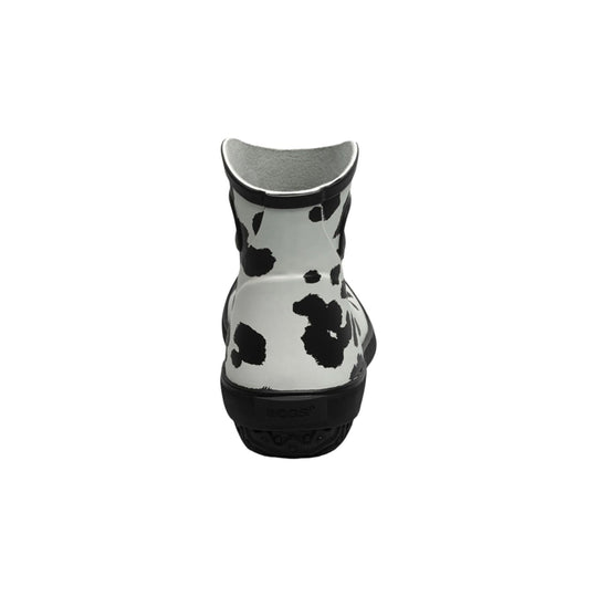 Black-and-white cow print rain boot with a textured sole and pull-on shaft