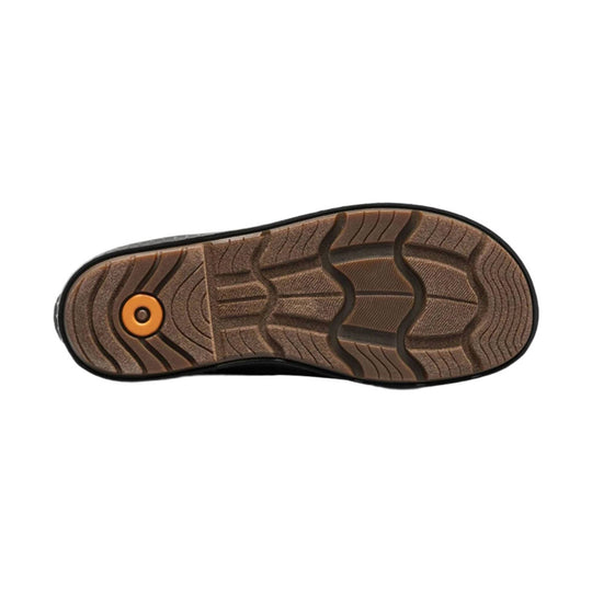 Brown boot outsole with black tread and an orange circular insert near the heel