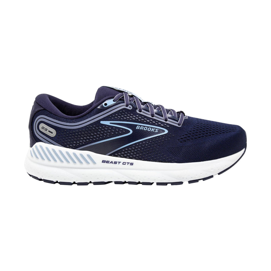 Navy running shoe with white cushioned sole and light blue accents, side view