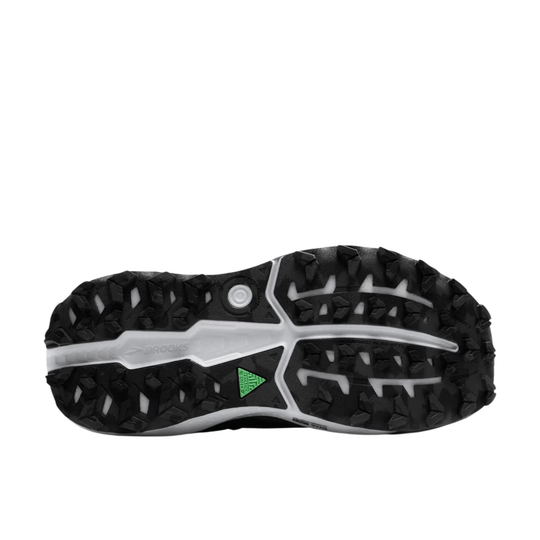 Black trail running shoe outsole with aggressive tread and white midfoot shank