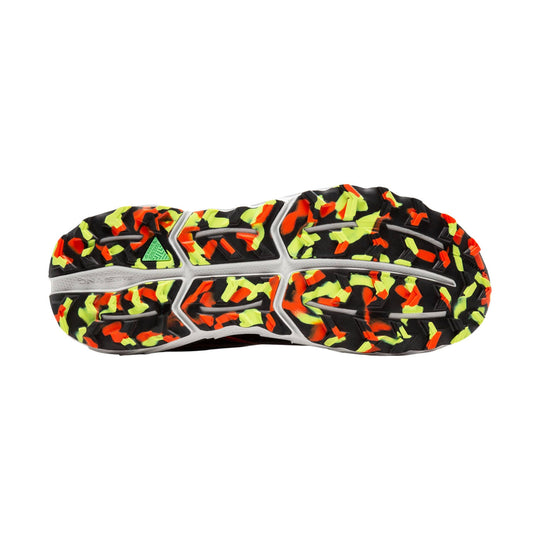 Trail shoe outsole with black lugs and neon yellow and orange camo pattern