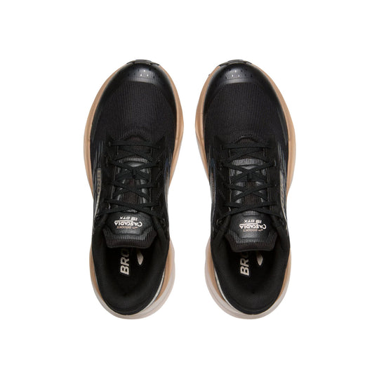 Black trail running shoes shown from above with tan midsoles and visible laces